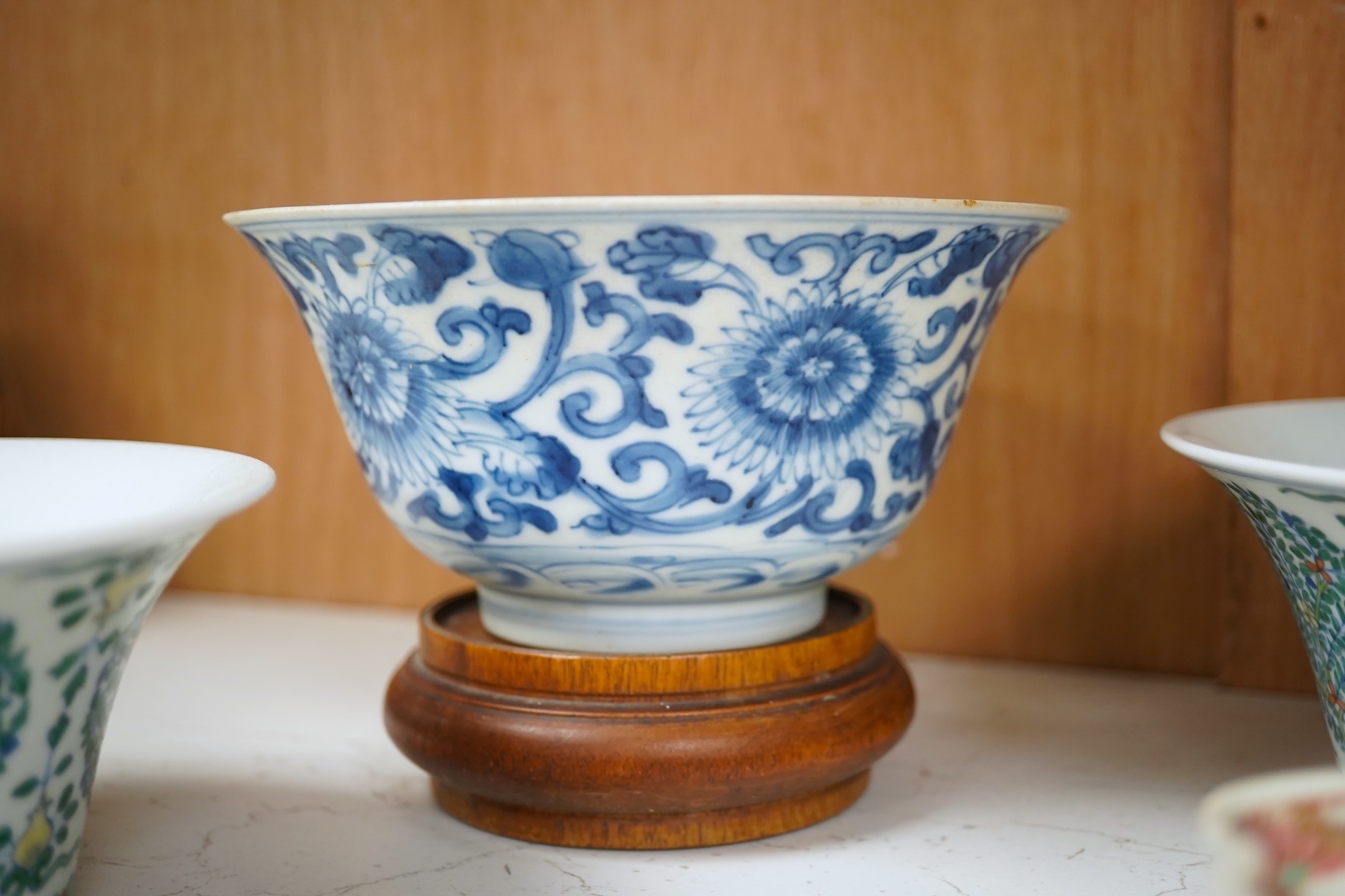 A Chinese blue and white bowl, Kangxi, 15cm. diam., a famille rose teapot stand, Yongzheng, and two doucai bowls. Condition - varies